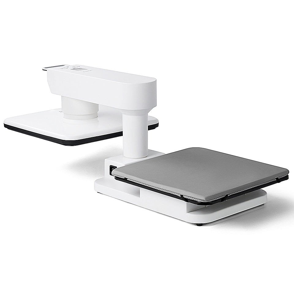 A three-quarter perspective of an "obziy" brand automatic garment press, presented on a white background. The device is shown open, with the white top pressing unit raised by its central column above the flat, grey-padded lower pressing board. A small digital display is visible on the upper unit.